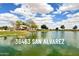 Scenic view of the community lake with lush green landscape at 36463 W San Alvarez Ave, Maricopa, AZ 85138