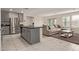 Modern kitchen with stainless steel appliances, gray cabinets, and open to the living area at 36463 W San Alvarez Ave, Maricopa, AZ 85138
