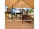 Community playground with multiple slides and covered sun shade at 36463 W San Alvarez Ave, Maricopa, AZ 85138