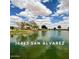 Community pond, under blue skies and puffy white clouds, with trees and picnic area at 36463 W San Alvarez Ave, Maricopa, AZ 85138