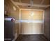 A utility room showing a water heater and wall damage in need of repair at 3719 W Thunderbird Rd, Phoenix, AZ 85053