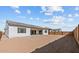 Expansive backyard featuring a retaining wall for added privacy at 37627 W Padilla St, Maricopa, AZ 85138