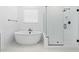 Spa-like bathroom with a modern tub and a walk-in shower at 37627 W Padilla St, Maricopa, AZ 85138
