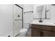 Contemporary bathroom with a glass-enclosed shower, modern vanity, and sleek fixtures at 37627 W Padilla St, Maricopa, AZ 85138