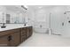 Luxurious bathroom showcasing a soaking tub and a glass-enclosed shower at 37627 W Padilla St, Maricopa, AZ 85138