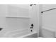 Clean bathroom featuring a white tub and shower combination, and sleek black hardware at 37627 W Padilla St, Maricopa, AZ 85138