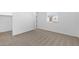 Empty bedroom with plush carpeting, a window, and a closet, ready for personalization at 37627 W Padilla St, Maricopa, AZ 85138