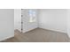 Bright bedroom featuring plush carpeting and a window letting in natural light at 37627 W Padilla St, Maricopa, AZ 85138