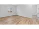 Bright, empty bedroom with light wood flooring and a large window providing ample natural light at 37627 W Padilla St, Maricopa, AZ 85138