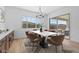 Bright dining room with modern table and chairs with stylish chandelier and exterior access at 37627 W Padilla St, Maricopa, AZ 85138