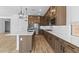 Bright kitchen featuring island with sink, stainless steel appliances and designer touches at 37627 W Padilla St, Maricopa, AZ 85138