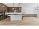 Spacious kitchen featuring long countertops, stainless steel appliances, and light flooring at 37627 W Padilla St, Maricopa, AZ 85138