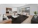 Open-concept living area showcasing stylish furnishings and seamless flow to the modern kitchen at 37627 W Padilla St, Maricopa, AZ 85138