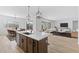 Open concept kitchen and living room perfect for entertaining and modern living at 37627 W Padilla St, Maricopa, AZ 85138