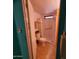 Full bathroom with a standing shower, toilet, and grab bar for easy access at 4065 E University Dr # 240, Mesa, AZ 85205