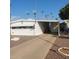 Charming single-story home with a driveway and mature palm trees in a well-maintained community at 4065 E University Dr # 240, Mesa, AZ 85205