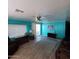 Bright and airy living room with wood laminate flooring, ceiling fan, and sliding glass door at 4065 E University Dr # 240, Mesa, AZ 85205