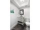 Clean bathroom with a white vanity, decorative mirror, and ample natural light at 4208 N Parkway Ave, Scottsdale, AZ 85251