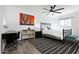 Bright bedroom featuring a modern ceiling fan, sleek desk and chair, and eye-catching cactus artwork at 4208 N Parkway Ave, Scottsdale, AZ 85251