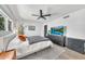 Airy bedroom features modern accents, a ceiling fan, and a large TV at 4208 N Parkway Ave, Scottsdale, AZ 85251