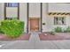 Beautiful double door entryway, complimented with red rock landscaping and lush green foliage at 4208 N Parkway Ave, Scottsdale, AZ 85251