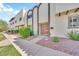 Stately townhome entrance with a decorative double door, red rock landscaping, and verdant bushes at 4208 N Parkway Ave, Scottsdale, AZ 85251