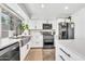 Modern kitchen with stainless steel appliances, white cabinets, and a farmhouse sink at 4208 N Parkway Ave, Scottsdale, AZ 85251