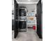 Convenient laundry closet with stacked washer/dryer and storage shelves at 4208 N Parkway Ave, Scottsdale, AZ 85251