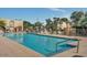 A spacious community swimming pool is surrounded by lounge chairs, tables, and umbrellas at 4208 N Parkway Ave, Scottsdale, AZ 85251