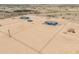 Desert property with a modern home, storage containers, fencing, and natural landscape at 43481 W Carefree Pl, Maricopa, AZ 85138