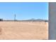 View of desert landscape with fencing and distant mountains at 43481 W Carefree Pl, Maricopa, AZ 85138