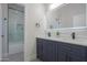 Modern bathroom boasts double vanity, matte black fixtures, and walk-in shower with marble surround at 43481 W Carefree Pl, Maricopa, AZ 85138
