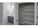 Stylish bathroom showcases vanity and closet with shelving for optimal storage at 43481 W Carefree Pl, Maricopa, AZ 85138