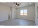 Bright bedroom features a ceiling fan, recessed lighting, and wood-style tile flooring at 43481 W Carefree Pl, Maricopa, AZ 85138