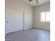 Bright bedroom features wood-look tile flooring, ceiling fan, closet, and a bright window at 43481 W Carefree Pl, Maricopa, AZ 85138
