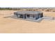 A modern single-story home with a gray tiled roof and a covered patio surrounded by desert landscape at 43481 W Carefree Pl, Maricopa, AZ 85138