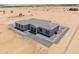 A modern single-story home with a gray roof, set in a desert landscape and surrounded by gravel at 43481 W Carefree Pl, Maricopa, AZ 85138