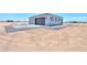 Detached garage with paved surroundings in a desert setting at 43481 W Carefree Pl, Maricopa, AZ 85138