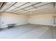Spacious two car garage with concrete flooring, painted walls, and a white door at 43481 W Carefree Pl, Maricopa, AZ 85138