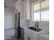 Stylish kitchen featuring white cabinets, a stainless steel refrigerator, a modern faucet, and quartz countertops at 43481 W Carefree Pl, Maricopa, AZ 85138