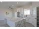 Modern kitchen with a large white quartz island, stainless steel appliances, and ample cabinet space at 43481 W Carefree Pl, Maricopa, AZ 85138