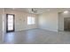 Bright, open living area with stylish floors, large windows, modern decor, and seamless transitions at 43481 W Carefree Pl, Maricopa, AZ 85138