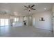 Bright living room featuring light wood floors, ceiling fans, an open-concept layout and a view of the kitchen at 43481 W Carefree Pl, Maricopa, AZ 85138