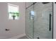 Walk-in shower with marble-look tile surround and glass enclosure at 43481 W Carefree Pl, Maricopa, AZ 85138