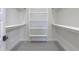 Walk-in closet with wood-style tile flooring and ample shelving space at 43481 W Carefree Pl, Maricopa, AZ 85138