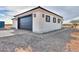 Detached garage featuring a modern black door and paver accents at 43481 W Carefree Pl, Maricopa, AZ 85138