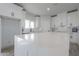 Bright kitchen featuring white cabinets, quartz countertops, and a spacious island at 43481 W Carefree Pl, Maricopa, AZ 85138