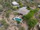 Aerial view showcasing home, lush desert landscaping, and refreshing backyard pool at 4684 E Coachwhip Rd, Cave Creek, AZ 85331
