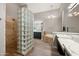 Elegant bathroom featuring tiled shower, glass block wall, soaking tub, and modern fixtures at 4684 E Coachwhip Rd, Cave Creek, AZ 85331