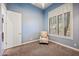 Comfortable bedroom with blue walls, plush carpet, and window with white plantation shutters at 4684 E Coachwhip Rd, Cave Creek, AZ 85331